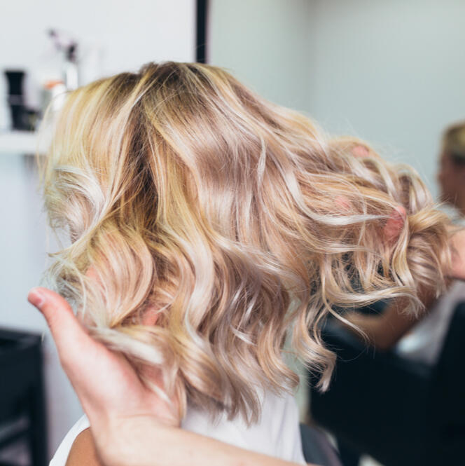 Soft blonde balayage with a loose wave finish